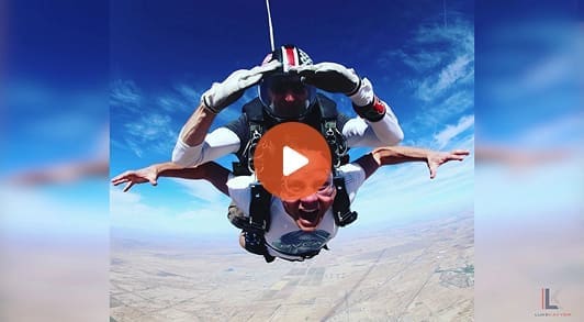 Screenshot of someone doing skydiving with play button